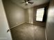 This bedroom has a ceiling fan, carpet and a window at 2705 E Rock Wren Rd, Phoenix, AZ 85048