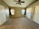 Neutral bedroom featuring two windows, a ceiling fan, and a large closet, providing ample storage at 2705 E Rock Wren Rd, Phoenix, AZ 85048