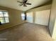 Cozy bedroom with carpet flooring, ceiling fan, and a large window offering natural light at 2705 E Rock Wren Rd, Phoenix, AZ 85048