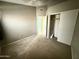 This bedroom has carpet, a closet and access to the hallway at 2705 E Rock Wren Rd, Phoenix, AZ 85048