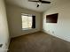 This bedroom has carpet, a ceiling fan and a window at 2705 E Rock Wren Rd, Phoenix, AZ 85048