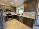 Updated kitchen featuring stainless steel appliances, granite countertops, and tile backsplash at 2705 E Rock Wren Rd, Phoenix, AZ 85048