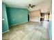 Bright living room with neutral tile flooring featuring a ceiling fan and an opening to the kitchen at 2705 E Rock Wren Rd, Phoenix, AZ 85048