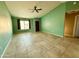 Spacious living room with neutral tile flooring, ceiling fan, and plenty of natural light from the window at 2705 E Rock Wren Rd, Phoenix, AZ 85048