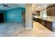 Open floor plan showcasing the living room and kitchen with updated cabinets and stainless steel appliances at 2705 E Rock Wren Rd, Phoenix, AZ 85048