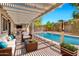Inviting back patio under a pergola overlooking the pool and outdoor seating area perfect for entertaining at 2741 S Brooks --, Mesa, AZ 85202