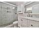 Modern bathroom with a glass-enclosed shower featuring decorative tiles and a vanity with marble countertop at 2741 S Brooks --, Mesa, AZ 85202