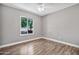 Bright empty bedroom with hardwood floors and natural light coming from a beautiful window at 2741 S Brooks --, Mesa, AZ 85202