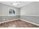 Cozy bedroom with two-tone walls and hardwood floors featuring a bright window for natural light at 2741 S Brooks --, Mesa, AZ 85202