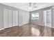 Spacious bedroom with hardwood floors, a ceiling fan, and ample closet space with many bi-fold doors at 2741 S Brooks --, Mesa, AZ 85202