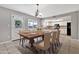 Elegant dining room showcasing a large wooden table with seating and views of the kitchen with black appliances at 2741 S Brooks --, Mesa, AZ 85202