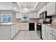 Charming kitchen featuring white cabinets, neutral walls, and modern appliances creating an inviting and functional space at 2741 S Brooks --, Mesa, AZ 85202