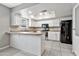 Bright kitchen featuring white cabinets, stainless steel appliances, and a breakfast bar with wood countertops at 2741 S Brooks --, Mesa, AZ 85202