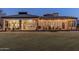 Expansive backyard with a covered patio, string lights, and a large grassy area, perfect for outdoor activities and relaxation at 2782 E Citadel Ct, Gilbert, AZ 85298