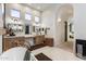 Bright bathroom featuring dual vanities, stylish mirrors, a soaking tub, and an arched doorway at 2782 E Citadel Ct, Gilbert, AZ 85298