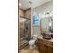 Stylish bathroom features a modern shower, a wood vessel sink, and travertine tile at 2782 E Citadel Ct, Gilbert, AZ 85298
