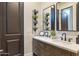 Elegant bathroom featuring dual sinks, a large mirror, a plant wall and stylish modern fixtures at 2782 E Citadel Ct, Gilbert, AZ 85298