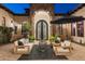 Inviting courtyard with cozy seating area and statement stone turret entrance with wrought iron doors at 2782 E Citadel Ct, Gilbert, AZ 85298
