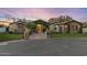 Stunning home exterior with stone accents, lush landscaping, and a circular driveway, showcasing luxurious curb appeal at 2782 E Citadel Ct, Gilbert, AZ 85298