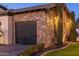 Stylish stone garage with a dark garage door and manicured landscaping, enhancing the curb appeal of the property at 2782 E Citadel Ct, Gilbert, AZ 85298