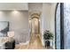 Inviting hallway with wood flooring, arched doorways, decorative lighting, and a view of the front door at 2782 E Citadel Ct, Gilbert, AZ 85298