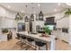 Open kitchen featuring a large center island with seating, custom cabinetry, and stainless steel appliances at 2782 E Citadel Ct, Gilbert, AZ 85298
