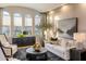 Elegant living room with arched windows, sophisticated decor, and a cozy seating area with neutral tones at 2782 E Citadel Ct, Gilbert, AZ 85298