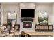 Cozy living room features a stone fireplace, TV, stylish decor, and inviting ambiance at 2782 E Citadel Ct, Gilbert, AZ 85298