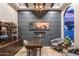 Cozy living room with a fireplace, built-in shelving, and a large window offering natural light at 2782 E Citadel Ct, Gilbert, AZ 85298