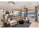 Expansive living room with an open floor plan, view of kitchen, and backyard access at 2782 E Citadel Ct, Gilbert, AZ 85298
