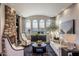 Bright living room featuring a stone fireplace, large windows, and stylish seating for comfortable living at 2782 E Citadel Ct, Gilbert, AZ 85298