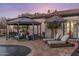 Luxurious backyard featuring a pool, cabana with seating, and lounge chairs for ultimate relaxation and entertainment at 2782 E Citadel Ct, Gilbert, AZ 85298