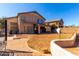 View of the expansive backyard with a covered patio, perfect for outdoor entertaining at 2841 S Esmeralda Cir, Mesa, AZ 85212