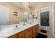 Bathroom featuring a double sink vanity and a separate shower with a patterned curtain at 2841 S Esmeralda Cir, Mesa, AZ 85212