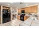 Inviting kitchen with black appliances, wood cabinetry, tile floors, and an arched doorway at 2841 S Esmeralda Cir, Mesa, AZ 85212