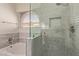 Modern bathroom featuring tiled walk-in shower with glass door, and a soaking tub at 2904 E Ludlow Dr, Phoenix, AZ 85032