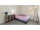 Cozy bedroom showcasing a bed, storage shelving, and natural light from the window at 2904 E Ludlow Dr, Phoenix, AZ 85032
