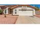 View of the front of a single-Gathering home with desert landscaping, tile roof and two-car garage at 2904 E Ludlow Dr, Phoenix, AZ 85032