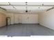 Spacious two car garage featuring an epoxy floor, storage cabinets, and two entry doors at 2904 E Ludlow Dr, Phoenix, AZ 85032