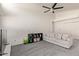 Cozy living room with a comfortable couch, neutral carpet, and a modern ceiling fan at 2904 E Ludlow Dr, Phoenix, AZ 85032