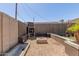Well-kept backyard with outdoor fireplace, seating area, and hardscape features at 3301 E Sharon Dr, Phoenix, AZ 85032