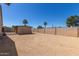 Large gravel backyard with block wall and storage buildings at 3301 E Sharon Dr, Phoenix, AZ 85032