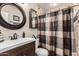 The remodeled bathroom showcases a modern vanity, decor, and shower with designer tiles at 3301 E Sharon Dr, Phoenix, AZ 85032