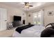 Bright bedroom featuring a ceiling fan, French doors to backyard, and neutral walls at 3301 E Sharon Dr, Phoenix, AZ 85032