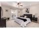 Comfortable bedroom with ceiling fan, carpeting, and French doors to outside at 3301 E Sharon Dr, Phoenix, AZ 85032