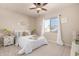 Bright bedroom features a ceiling fan, neutral walls, and a light-filled window at 3301 E Sharon Dr, Phoenix, AZ 85032