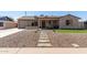 Charming home featuring a desert landscaped yard with a stone pathway leading to the front door at 3301 E Sharon Dr, Phoenix, AZ 85032