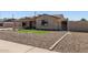 Attractive home featuring easy-care desert rock landscaping and a welcoming front entrance at 3301 E Sharon Dr, Phoenix, AZ 85032