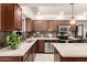 Kitchen highlighting stainless steel appliances, dark cabinets, modern backsplash, and ample counter space at 3301 E Sharon Dr, Phoenix, AZ 85032
