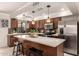 Kitchen featuring stainless steel appliances, dark cabinetry, and a white countertop island with barstool seating at 3301 E Sharon Dr, Phoenix, AZ 85032